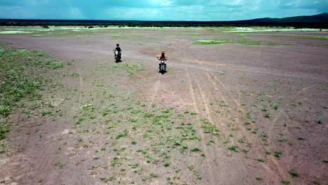 Two-Adventurous-Riders-Riding-Motorcycles-To-Lake-Magadi,-Kenya