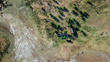 A-Group-Of-People-With-Tents-Is-Camping-Near-Lake-Magadi-In-The-Great-Rift-Valley,-Southern-Kenya
