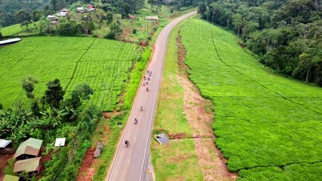 Riders-Riding-Motorcycles-On-The-Road-Between-The-Green-Tea-Plantation-In-Chogoria,-Kenya