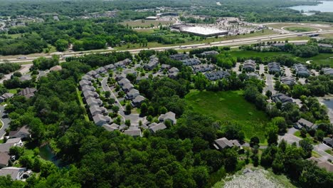Drone-shot-of-a-housing-development-next-to-a-highway-or-freeway