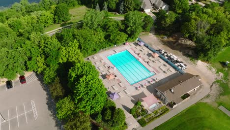 Drone-shot-of-an-outdoor-public-lap-pool-with-bright-blue-water