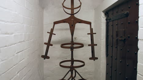 A-medieval-middles-ages-torture-chamber-in-a-dungeon-prison-cell-with-an-iron-man