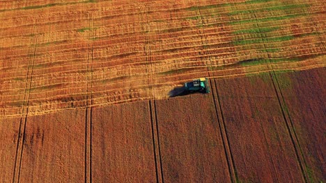 Aerial-View-Of-Harvester-Cutting-Crop-Of-Wheat-On-Harvesting-Season