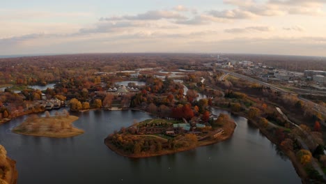 Glencoe,-Illinois,-USA-:Aerial-drone-backward-moving-shot-over-Chicago-Botanic-Garden-during-autumn-season-with-small-lakes