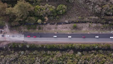 Aerial-top-down-view-of-a-traffic-jam-on-a-rural-forest-road-in-southern-uruguay