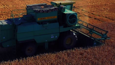 Crop-Harvesting-With-Combine-Harvester-In-The-Field-In-Lithuania---drone-shot