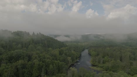 Drone-hovering-looking-at-beautiful-foggy-mountain-top-landscape-1