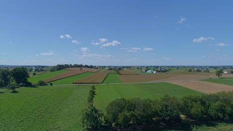 An-Aerial-View-of-Corn-and-Alfalfa-Fields-with-a-Amish-Horse-and-Buggy-Traveling-on-a-Country-Road-on-a-Fall-Day