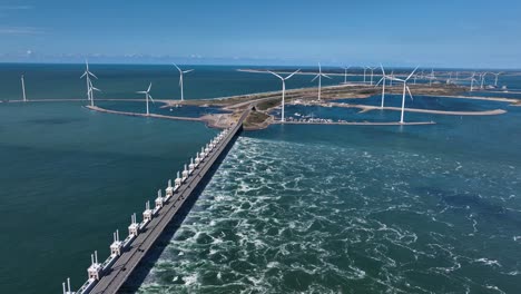 Aerial-Drone-Shot-of-Oosterschelde-Storm-Surge-Barrier-with-Green-Energy-Wind-Farm-In-the-Background