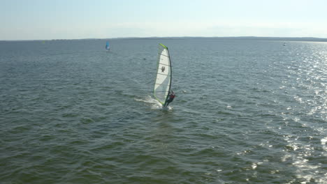 Windsurfer-Floats-On-A-Board-With-A-Sail-At-Midday