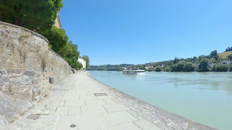 Cruise-boat-tour-on-Inn-river-in-historic-city-Passau,-Germany