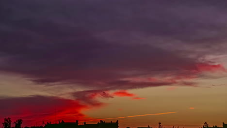 Time-lapse-shot-of-red-colored-clouds-flying-at-sky-after-golden-sunset
