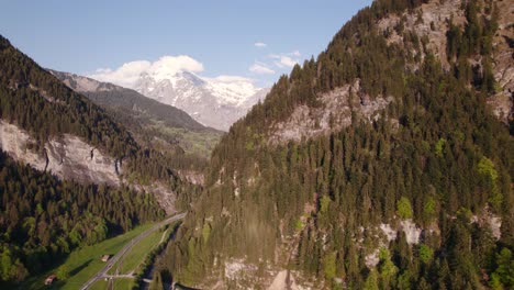 Aerial-drone-footage-pushing-in-right-to-left-with-stunning-views-of-snowy-Wetterhorn-and-Schreckhorn-in-Grindelwald-in-Switzerland