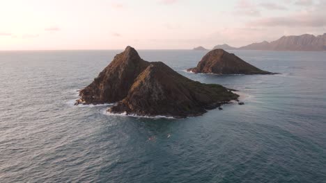 Incredible-nature-beauty-of-Na-Mokulua-Hawaiian-small-basaltic-islands-called-Moku-Nui-and-Moku-Iki-at-sunset,-Hawaii