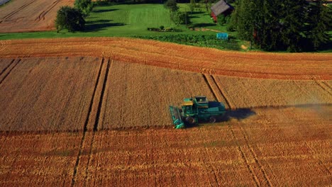 Working-Combine-Harvester-In-Vast-Farmland-During-Sunset