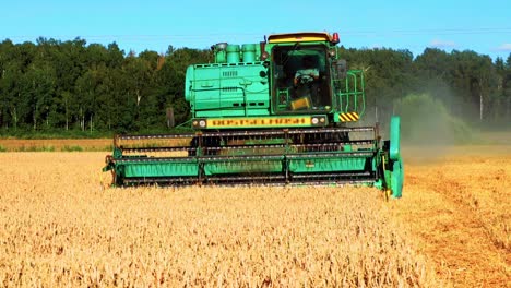 Combine-Harvester-Head-Harvesting-The-Wheat-Field-In-Lithuania---pullback