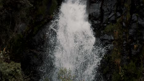 Water-Cascading-Down-On-Rocks-In-A-Mountain-Forest---Cayambe-Coca-National-Park-In-Papallacta,-Ecuador---slow-motion