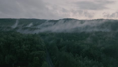 Drone-hovering-looking-at-beautiful-foggy-mountain-top-landscape-3