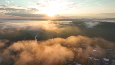 Aerial-flight-above-clouds-at-sunrise