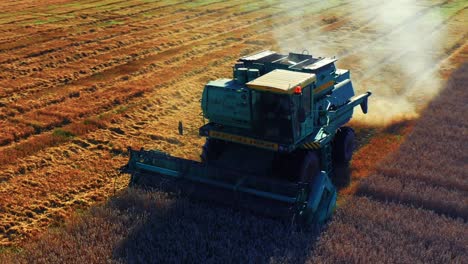 A-Combine-Harvester-Collecting-And-Harvesting-Crop-In-The-Field-In-Lithuania---drone-shot
