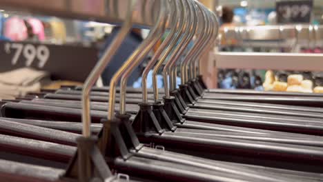 A-close-up-shot-of-few-hangers-placed-in-a-queue-in-a-cloth-store