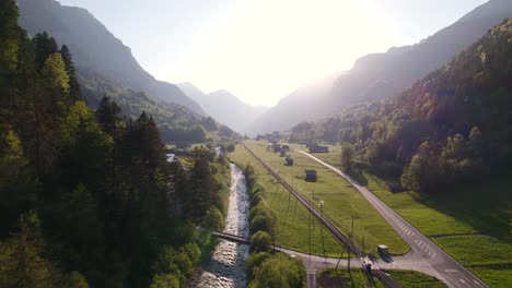 Aerial-drone-footage-pushing-in-and-raising-down-along-black-luetschine-revealing-beautiful-sunset-views-between-Grindelwald-and-Burglauenen-in-the-Swiss-Alps