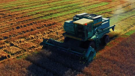 Large-Modern-Combine-Harvester-At-Work-In-The-Field-In-Lithuania---drone-shot