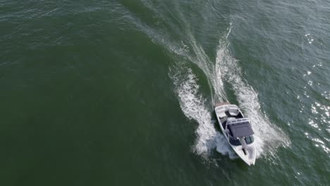 Aerial-view-of-a-boat-speeding-past-on-the-lake