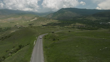 Slow-Motion-Of-A-White-Car-Traveling-On-The-Road-Near-Sakudaberi-And-Aspindza-In-Georgia