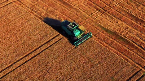 Combine-Harvester-On-Wheat-Field-In-The-Countryside-Of-Lithuania---aerial-shot