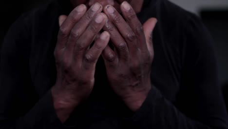Man-praying-to-god-with-hands-together-Caribbean-man-praying-with-black-background-stock-footage