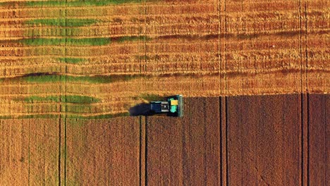 Orbiting-Over-Combine-Harvester-Tractor-During-Sunset-In-Lithuania