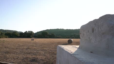 Progressive-discovery-of-a-field-harvested-at-sunrise-with-round-straw-bales