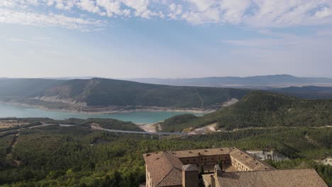 A-peaceful-Yesa-reservoir-and-Leyre-Monastery-with-drone-landing-behind