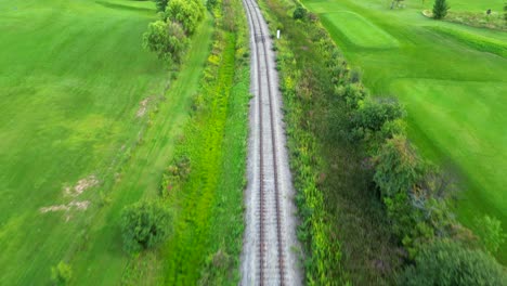Drone-flying-above-empty-train-track-in-countryside-and-nature