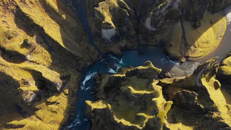 Fjaðrárgljúfur-canyon-flyover-looking-down-on-sunny-day-in-Iceland