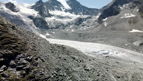 Slow-tilt-up-aerial-view-revealing-a-huge-glacier-in-Zinal-valley,-Switzerland