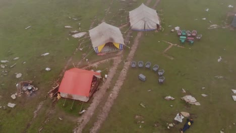 Aerial-Flying-Overhead-Over-Remote-Camping-Tents-On-Hilltop-At-Baboon-Valley-In-Kashmir-With-Rolling-Mist