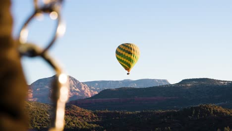 View-from-one-hot-air-balloon-of-another-floating-in-sky,-Sedona,-Arizona