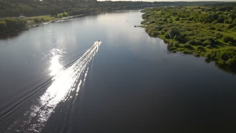 Aerial-shot-of-a-ferry-boat-sailing-on-river-Nemunas-with-beautiful-nature-near-Kaunas,-Lithuania-4