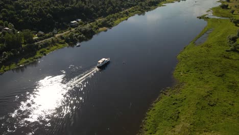 Aerial-shot-of-a-ferry-boat-sailing-on-river-Nemunas-with-beautiful-nature-near-Kaunas,-Lithuania-3