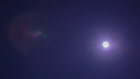 Time-lapse-shot-of-bright-shining-full-moon-rising-up-at-dark-sky-in-night