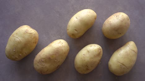 Stop-Motion-Of-Raw-Unpeeled-Potatoes-Filling-The-Surface-One-At-A-Time-And-Go