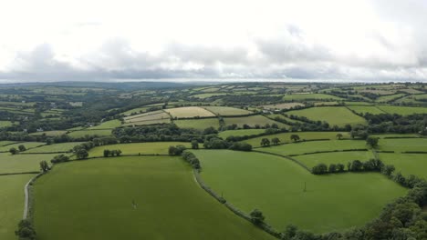 Idyllic-Rolling-Patchwork-Farmland---British-Greenery---aerial-drone-shot