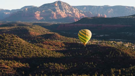 Hot-air-balloon-floats-over-scenic-Coconino-National-Forest,-Sedona,-Arizona