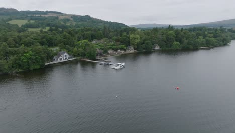 Closing-Shot-with-Tilt-Up-Of-A-Docked-Boat-On-The-Shores-Of-Loch-Lomond