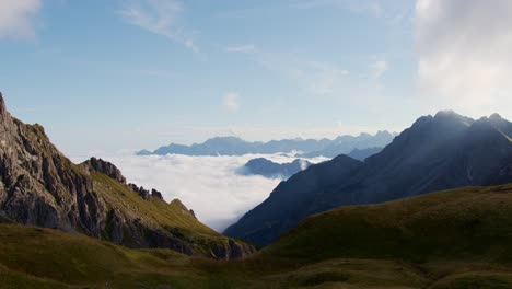 Clouds-lie-in-a-valley-with-mountains-around