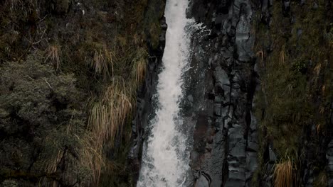 Waterfall-Plunging-And-Cascading-Over-Boulders-In-Cayambe-Coca-National-Park,-Papallacta,-Ecuador---tilt-down