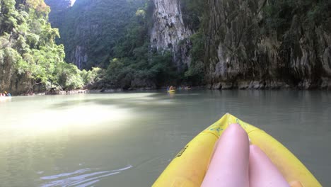 Go-Pro-perspective-slow-motion-of-caucasian-girls-legs-in-kayak-in-Thailand-with-beautiful-surroundings