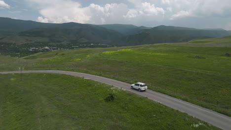 Lone-White-Car-Travelling-On-A-Paved-Road-Outside-Aspindza-District-In-Georgia